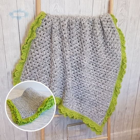 A light gray marled crochet blanket draped over a wooden ladder against a rustic paneled wall. The blanket features an open, textured stitch pattern and is framed by a wide, bright lime green ruffled or scalloped border. A circular inset shows the blanket folded diagonally on a white surface, highlighting the contrast between the gray body and green trim. This is a blanket pattern made by Ariana Wimsett of Crafting Happiness, a well known crocheter and author.