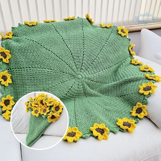 A large, round green crochet blanket spread across a white sofa. The blanket is worked in segments radiating from the center, and its scalloped outer edge is adorned with 3D crochet sunflowers featuring bright yellow petals and dark brown centers. A circular inset in the lower left corner shows the green blanket cleverly folded into a cone shape to look like a freshly picked bouquet of sunflowers. This is a blanket pattern made by Ariana Wimsett of Crafting Happiness, a well known crocheter and author.
