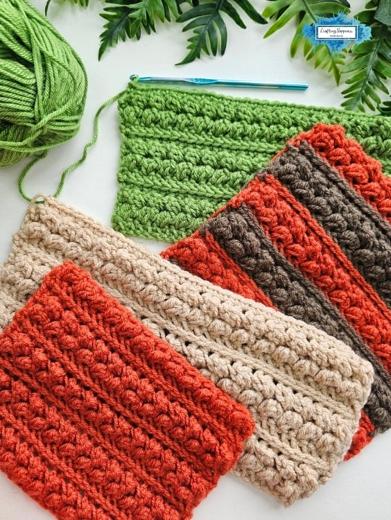 Several crochet swatches in orange, beige, brown, and green show the textured Braided Leaves Stitch, with a green yarn ball, crochet hook, and leafy greenery nearby. The Braided Leaves Stitch was designed by Ariana Wimsett, a known crocheter and author, and all the crochet work shown here was made by her.
