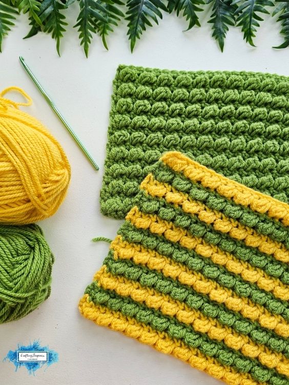 Green and yellow Sedum Stitch crochet swatches with raised textured rows, yarn, and crochet hook. By Ariana Wimsett of Crafting Happiness, a known crocheter and author.