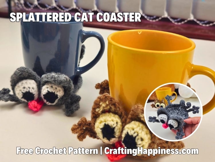 Two crochet splattered cat mug coasters wrapped around a dark blue mug and a mustard yellow mug. The gray and brown cats have oversized eyes, tiny pink noses, and spread-out paws, with a close-up inset showing the coaster shape. Includes the text "Splattered Cat Coaster" and "Free Crochet Pattern | CraftingHappiness.com." Original design by Ariana of CraftingHappiness.