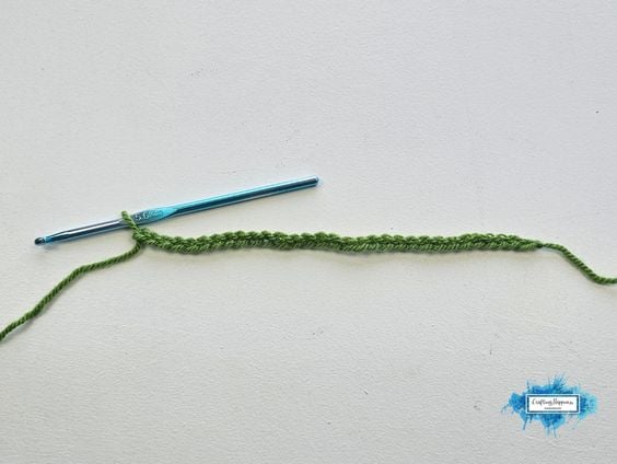 Starting chain for the Sedum Stitch worked in green yarn with a crochet hook. By Ariana Wimsett of Crafting Happiness, a known crocheter and author.